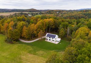 Aerial view of the Lewis Creek Cottage situated at the edge of the meadow.