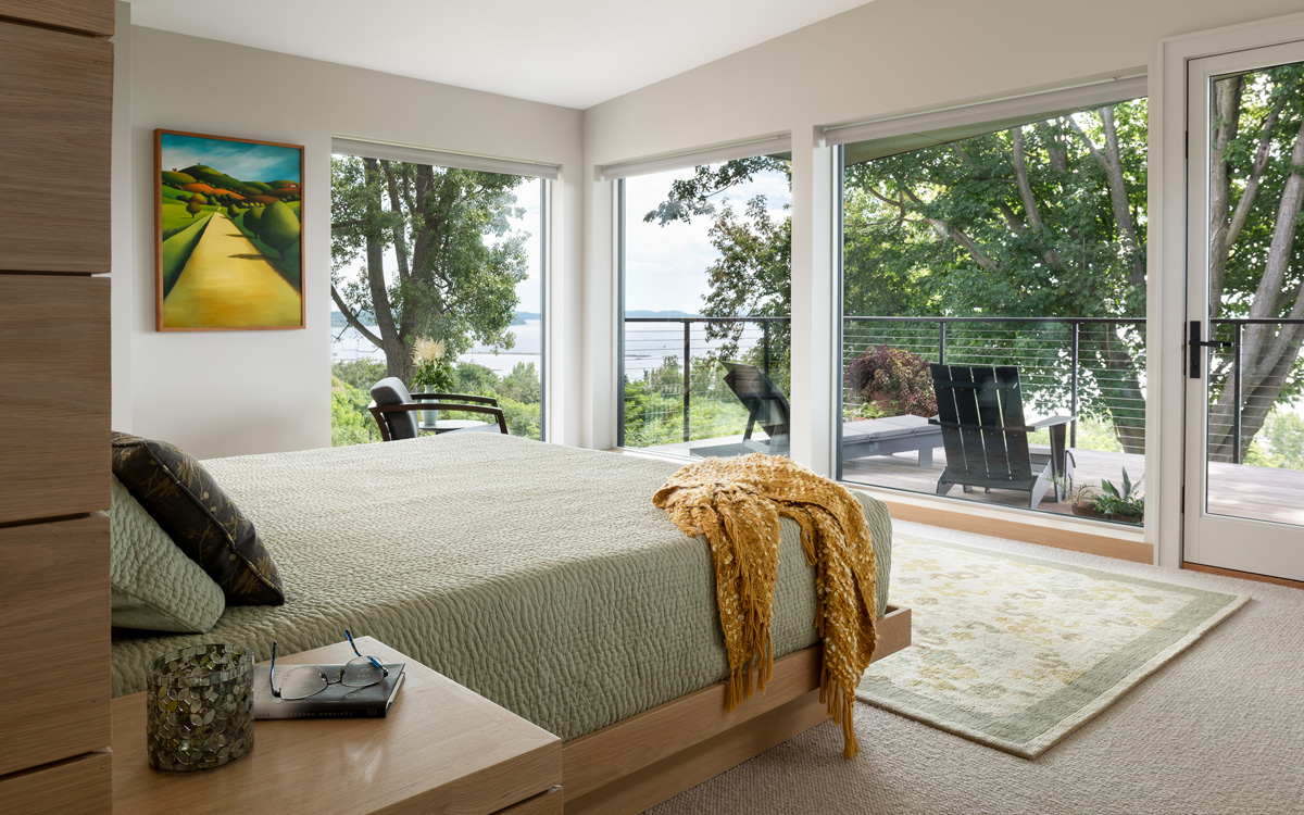 The master bedroom and balcony with views of the lake.