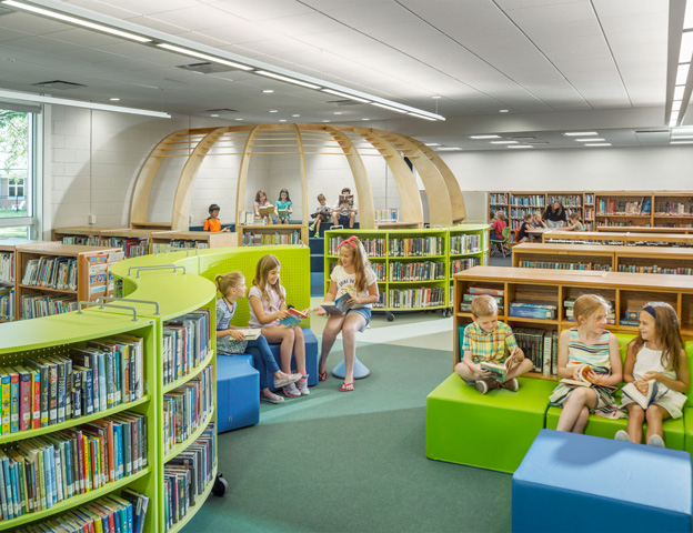 Williston Central School library with kids on chairs reading